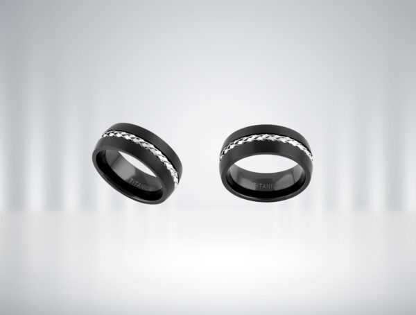 Two black rings with silver zigzag patterns floating against a gradient background.